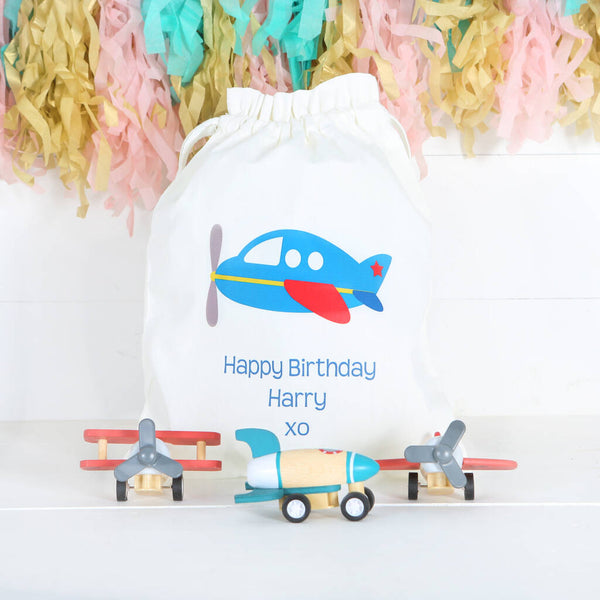 Wooden Planes And Rocket Toys In Personalised Bag